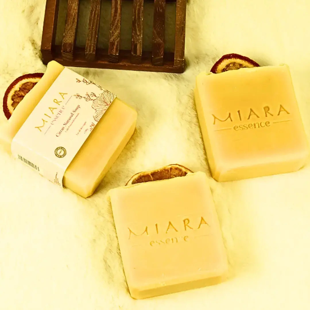 Miara Essence Citrus Natural Soap bars with citrus peels on a soft surface, showcasing their natural ingredients and clarity benefits.