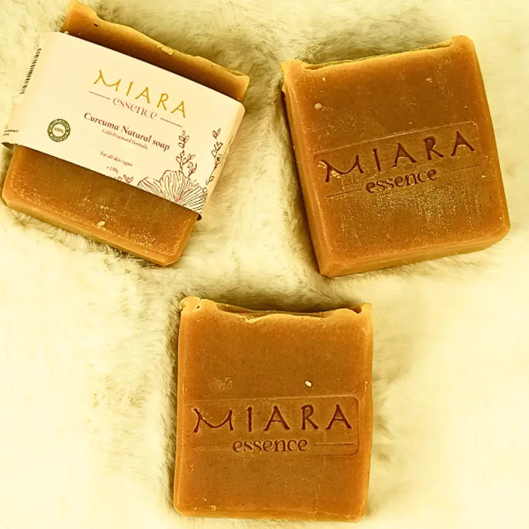 Miara Essence Curcuma Natural Soap bars displayed on a soft surface, featuring the product label.