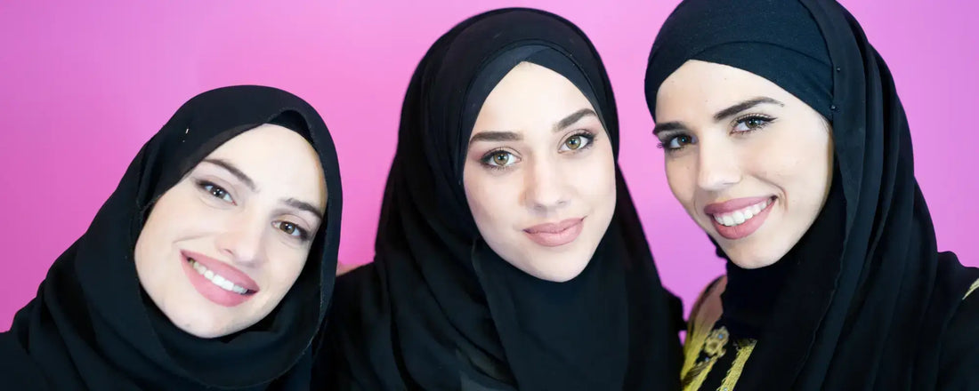 Womens Wellness during Ramadan: three women in hijabs smiling in front of a pink background.