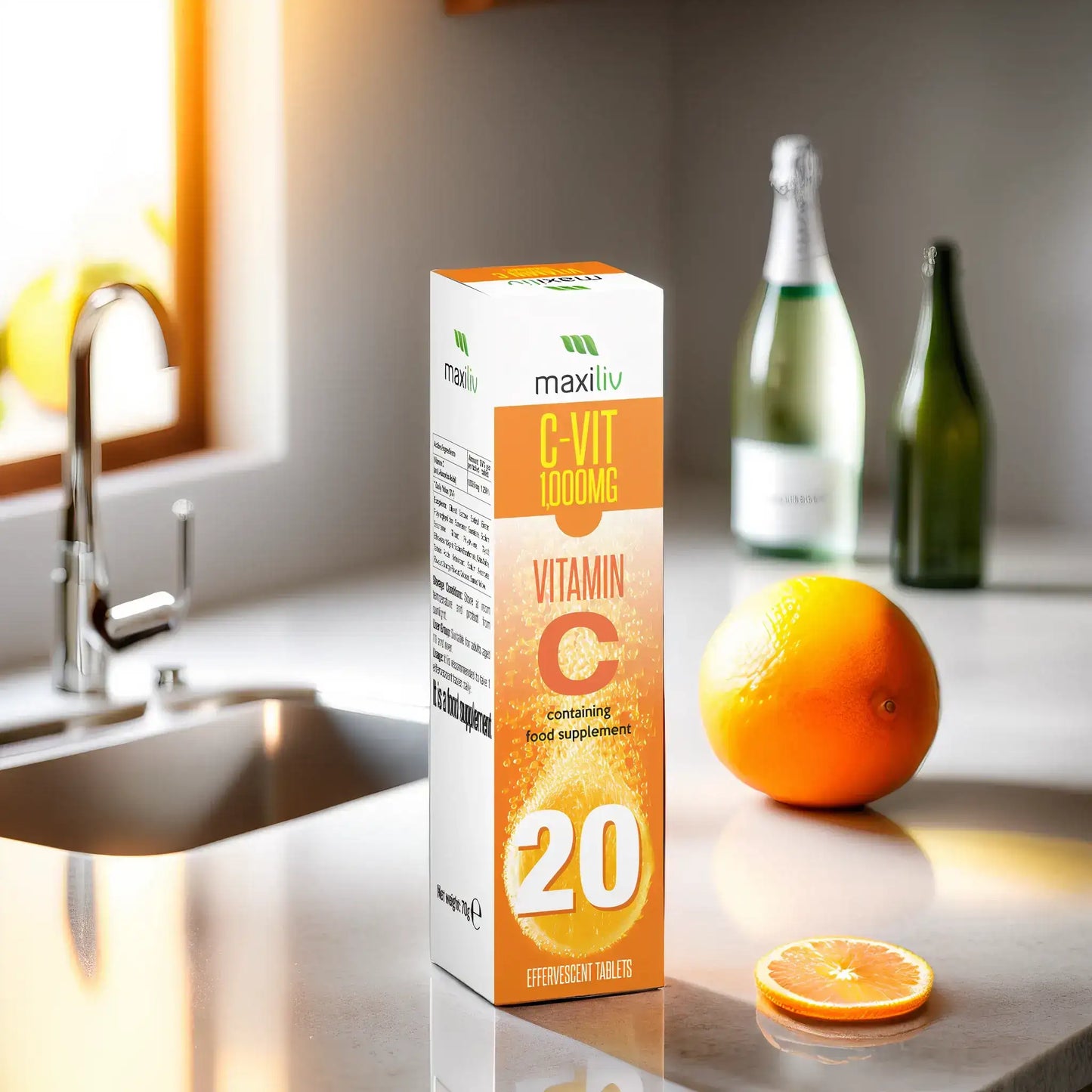 Maxiliv Vitamin C Effervescent tablets packaging on kitchen countertop with orange and sparkling water.