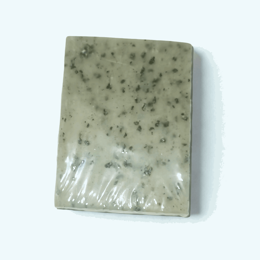 Rectangular soap bar Blackseed Natural Soap with speckled texture on a white background