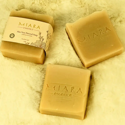 Three bars of Miara Essence Aloe Vera Natural soap on a textured beige surface