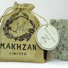 Makhzan Limited branded burlap bag with a blackseed natural soap bar on a white background