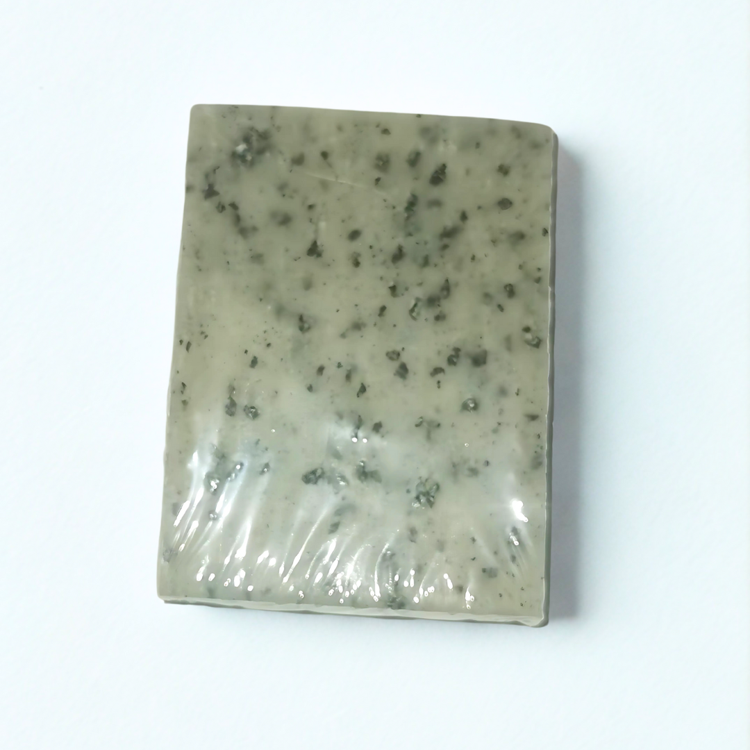 Rectangular soap bar Blackseed Natural Soap with speckled texture on a white background