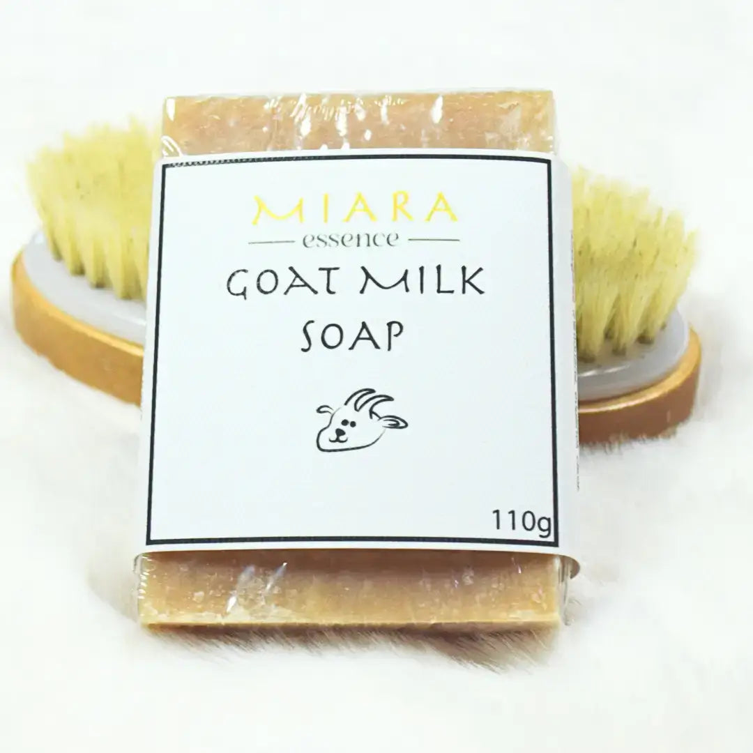 Miara Essence Goat Milk Natural Soap with packaging and a natural brush for radiant skin care.