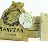 Bar of soap with a 'Makhzan Limited' burlap bag and a Miara Natural Vitamin E soap label.