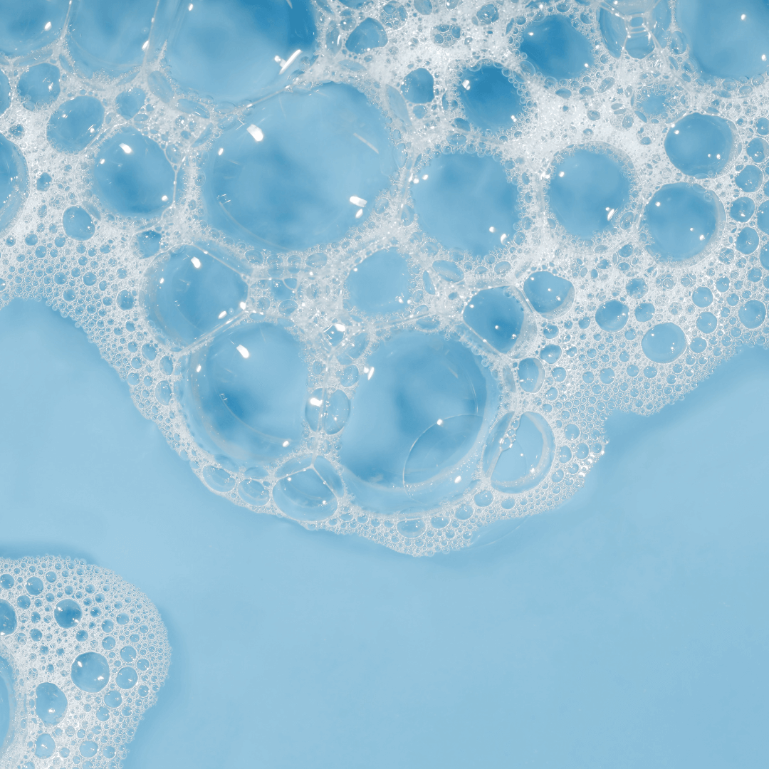 Close-up of blue bubbles from Miara Rice Powder Soap  on a blue background