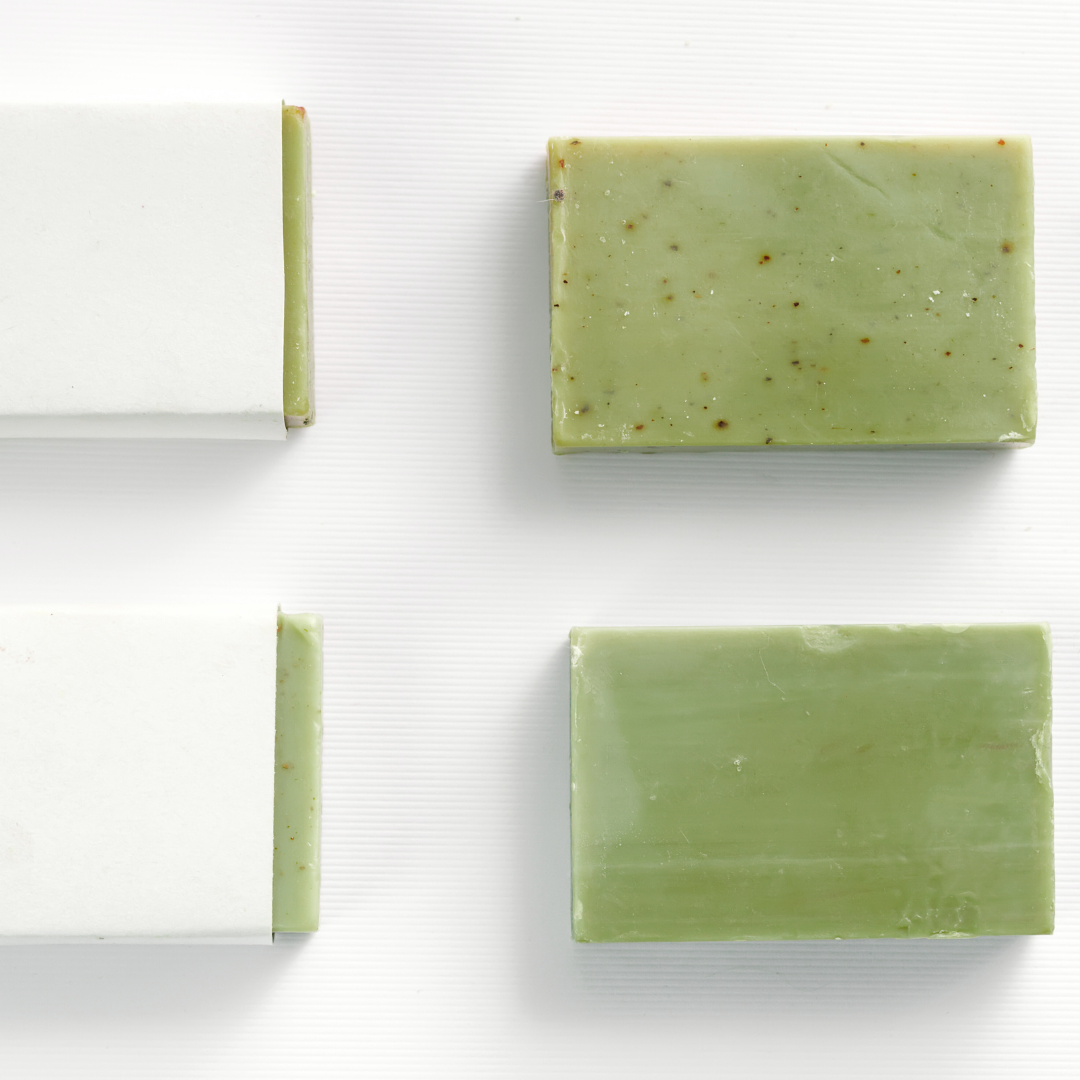 Three green natural olive oil soap bars on a white background
