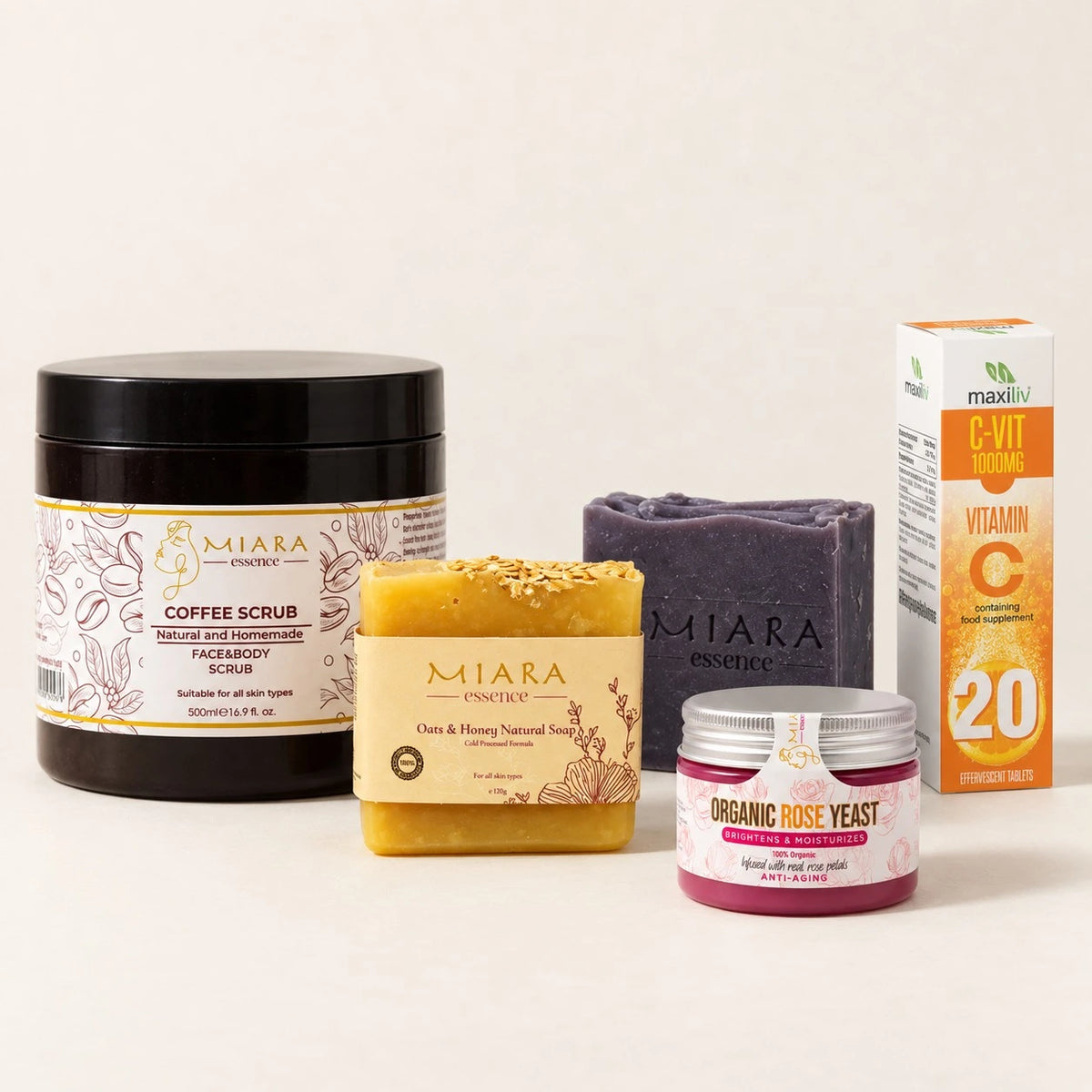 Shop by skin concerns curated skincare set featuring a black jar of Miara Coffee Scrub, a yellow bar of Miara Goo & Honey Natural Soap, a purple bar of Miara soap, a pink jar of Miara Organic Rose Yeast, and a Maxiv C-Vit D3 Vitamin C supplement box, arranged on a light beige background.